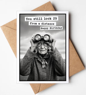 Colorful birthday greeting card by Katie Doodle with humorous "You Still Look 29 From A Distance" message and playful design.
