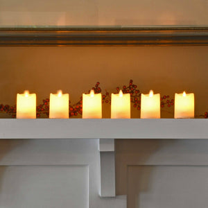 Set of six LumaBase battery-operated LED votive candles with flickering flame effect on a white surface.
