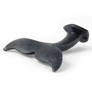 Black whale tail-shaped hook with a textured surface against a white background.
