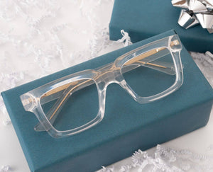 Peepers Spotlight reading glasses with clear frames and round lenses, positioned on a neutral background.