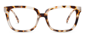Peepers Impromptu Chai Tortoise eyeglasses with round frames and tortoise pattern, resting on a white surface.