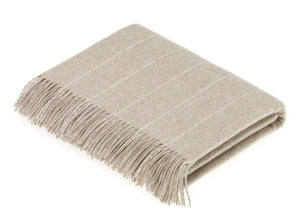 Soft Merino Lambswool throw and pillow from Bronte Moon's Classic Collection, featuring cozy, textured fabric in neutral tones.