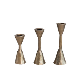Set of three hand-forged iron taper candleholders with antique brass finish by CCOI, featuring rustic, vintage-style design.