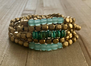 Turquoise glass and brass bracelet set from Nellie Pratt Artisan Jewelry with boho-style design and layered stacking.