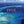 Aerial view of a turquoise ocean with a small island, text overlay: 
