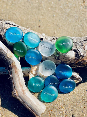 Imprinted glass word stones in a bowl display, featuring 60 Sea Stones by SHOPGIVECOURAGE for decorative or inspirational use.