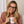 Peepers To the Max reading glasses with clear frames and adjustable temples, close-up shot showing stylish eyewear.