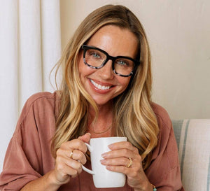 Peepers To the Max reading glasses with clear frames and adjustable temples, close-up shot showing stylish eyewear.