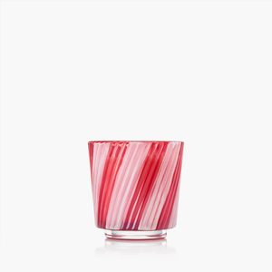 Red and white striped glass cup with a ribbed texture on a plain white background.