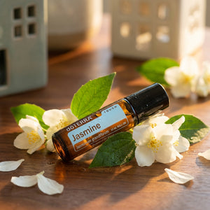 Pleasant Beach Living Jasmine essential oil roller ball from Doterra, featuring a clear glass bottle with a white roller ball applicator.