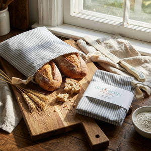 Set of two Dusty Blue Stripe Linen Bread Bags by Dot and Army, featuring natural linen texture and blue striped design for kitchen storage.