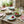 Small flower-shaped dinner plate by CCOI with reactive glaze finish, showcasing vibrant floral design and glossy surface.