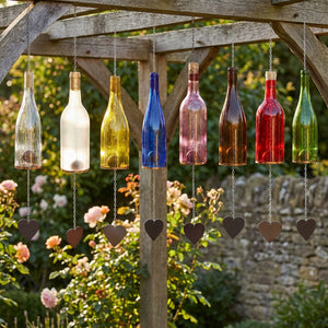 Colorful glass bottles hang on chains under a wooden frame with heart-shaped pendants.