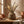 Ceramic vase with dried wheat and eucalyptus on a wooden table, warm earthy tones.