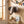 Elephant head decor on wooden wall, globe on shelf, colorful garlands, and toy blocks by window.