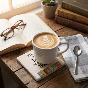 Round ceramic coaster featuring "All You Need Is Love and a Good Book" design by Tipsy Coasters & Gifts.