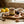 Jar of lemon fig marmalade on a wooden board with figs, lemons, cinnamon, and spoons of marmalade.