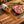Raw steak on a wood board with spilled seasoning, rosemary, garlic, and coarse salt.