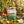 Bird call toy with birds, potted plants, flowers, ladybugs, bees, magnifying glass, and notes.