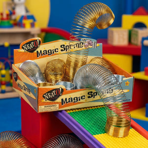Colorful metal springs in a box labeled "Magic Spring" on a vibrant, toy-filled background.