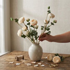 Fresh pink ranunculus flowers from Eucalypt Co. arranged in a bouquet with delicate petals and lush green foliage.