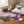 Lavender eye mask, sprigs of lavender, steaming diffuser, white pillow on a wooden table.