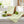 Green striped towels, limes, salt bowl, and mint on a white kitchen table with wooden accents.