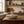 Ceramic dish with toothpicks on a wooden kitchen counter, with copper pots and a window.