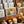 Greeting cards in a wooden display with lit candles nearby; art features flowers and fruit.
