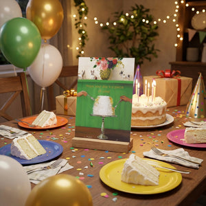 Table with colorful plates, cake slices, lit candles, balloons, confetti, and a birthday card.