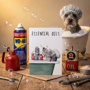 Dog in tub with shower cap, next to card titled "Essential Oils," surrounded by oil cans and bubbles.