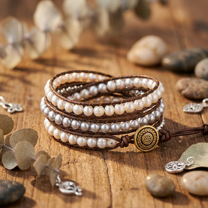 Two-tone freshwater pearl wrap bracelet with silver and gold accents, stylish jewelry accessory on a neutral background