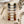 Velvet ribbons in various colors, scissors, thread spool, buttons, and measuring tape on a wooden surface.