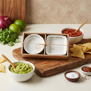 Ceramic bowls labeled "Guac & Roll" and "Let's Salsa" with guacamole, salsa, chips, and spices.