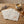 Beige napkins with pink embroidery, a mug of coffee, lavender, and honey on a wooden table.