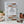 Open cookbook from The Cook’s Atelier by Abrams showing a colorful plated dish and kitchen utensils on a rustic table.