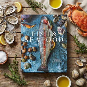 Seafood cookbook on ice with fish, oysters, crab, herbs, and lemon. Wooden table setting.