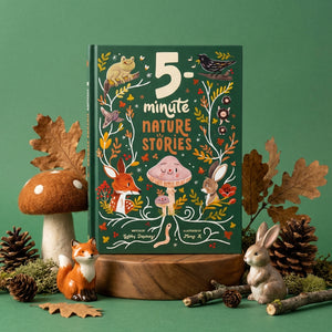 Children's book with nature-themed cover, surrounded by toy animals, leaves, and pinecones.