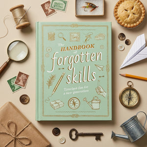 Open book titled "The Handbook of Forgotten Skills" by Abrams, featuring illustrated pages on various traditional crafts and skills.
