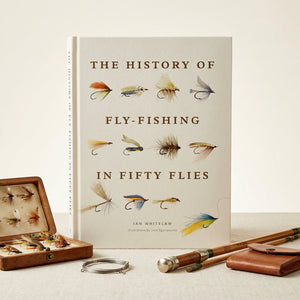 Open book titled "History of Fly-Fishing in Fifty Flies" by Abrams, featuring detailed illustrations of various fishing flies.