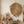 Dried palm leaf wall art above a rustic table with vases of pampas grass and cotton stems.