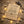 Brown card with star-themed text, a bracelet, surrounded by fairy lights on wooden surface.