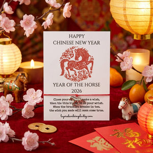 Chinese New Year card with red horse design, surrounded by pink blossoms, lanterns, and oranges.