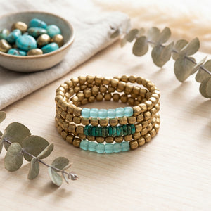 Turquoise glass and brass bracelet set from Nellie Pratt Artisan Jewelry featuring multiple layered bangles with intricate details.