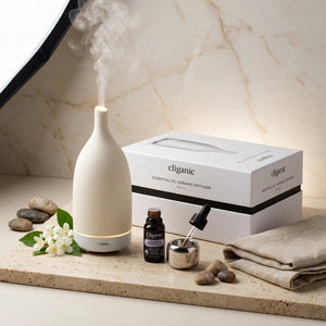 White ceramic aromatherapy essential oil diffuser by Cliganic, showcasing its sleek design and mist outlet for relaxing scents.