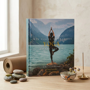 Open book titled "Fifty Places to Practice Yoga Before You Die" by Abrams, showing pages with yoga poses and scenic backgrounds.