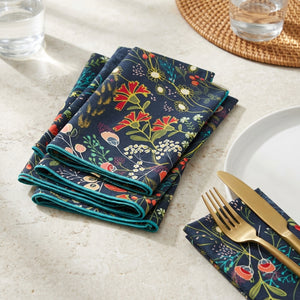 Set of four Pleasant Beach Living Pretty Peacock dinner cloth napkins with vibrant peacock feather design.
